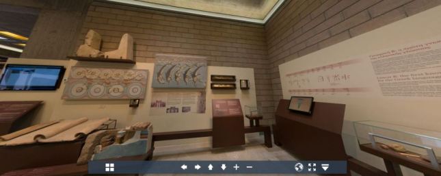 Virtual view of displays: straight ahead are reconstructed frescoes of dolphins and geometric patterns, with a 'horns of consecration' above; to right is display about Linear B script